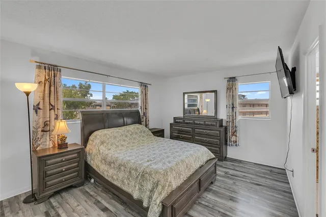 a bedroom with a bed and wooden floor
