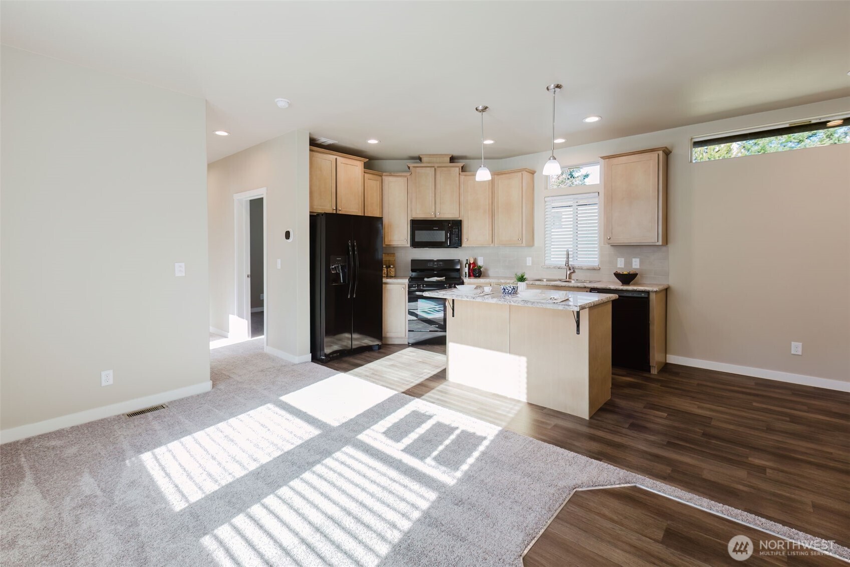 3371 Southeast Bielmeier Road, Unit 95 Port Orchard, WA 98367 - Photo 16 of 40 a kitchen with stainless steel appliances kitchen island granite countertop a refrigerator and a stove top oven