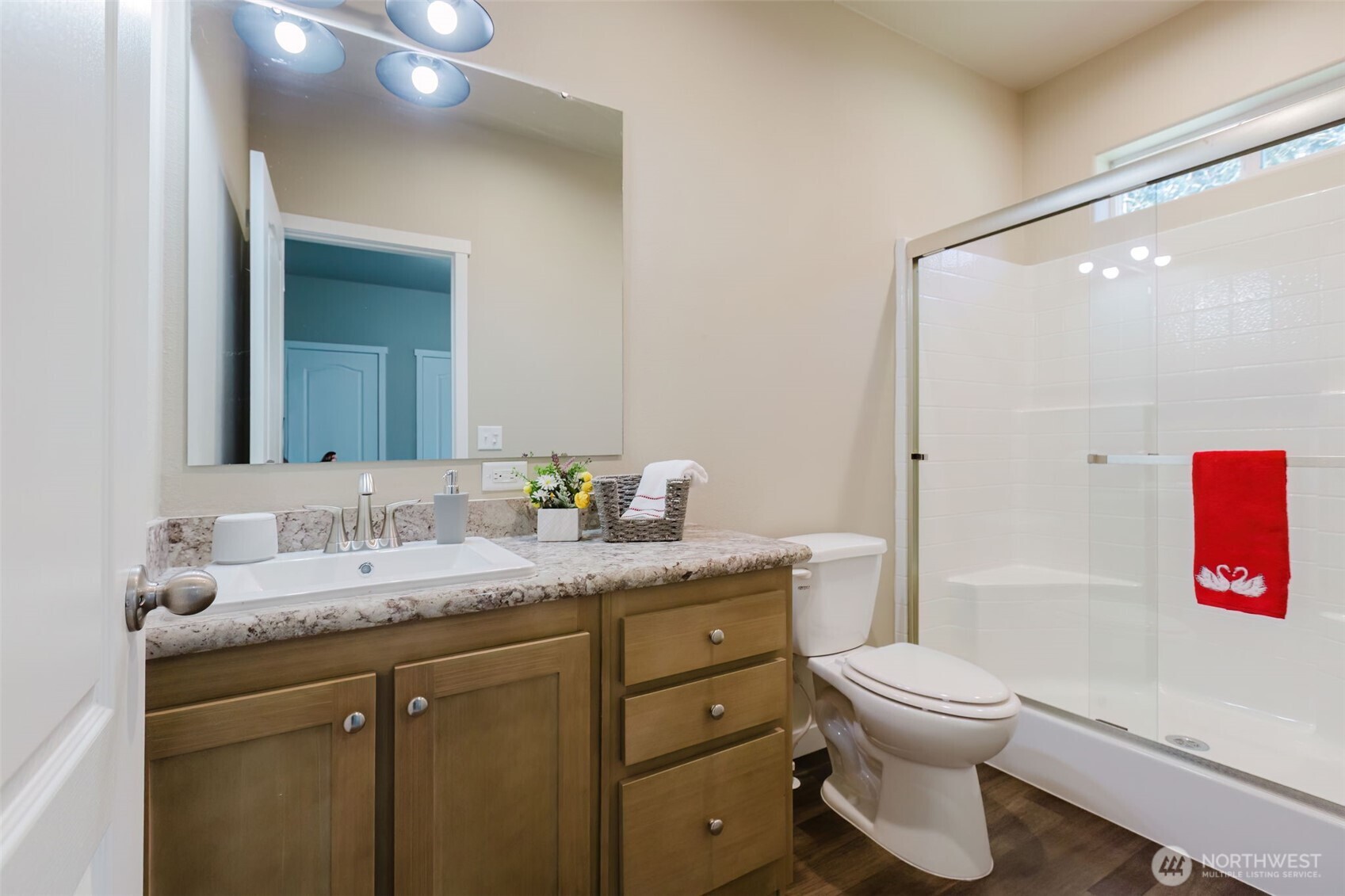 3371 Southeast Bielmeier Road, Unit 95 Port Orchard, WA 98367 - Photo 35 of 40 a bathroom with a granite countertop toilet sink and mirror