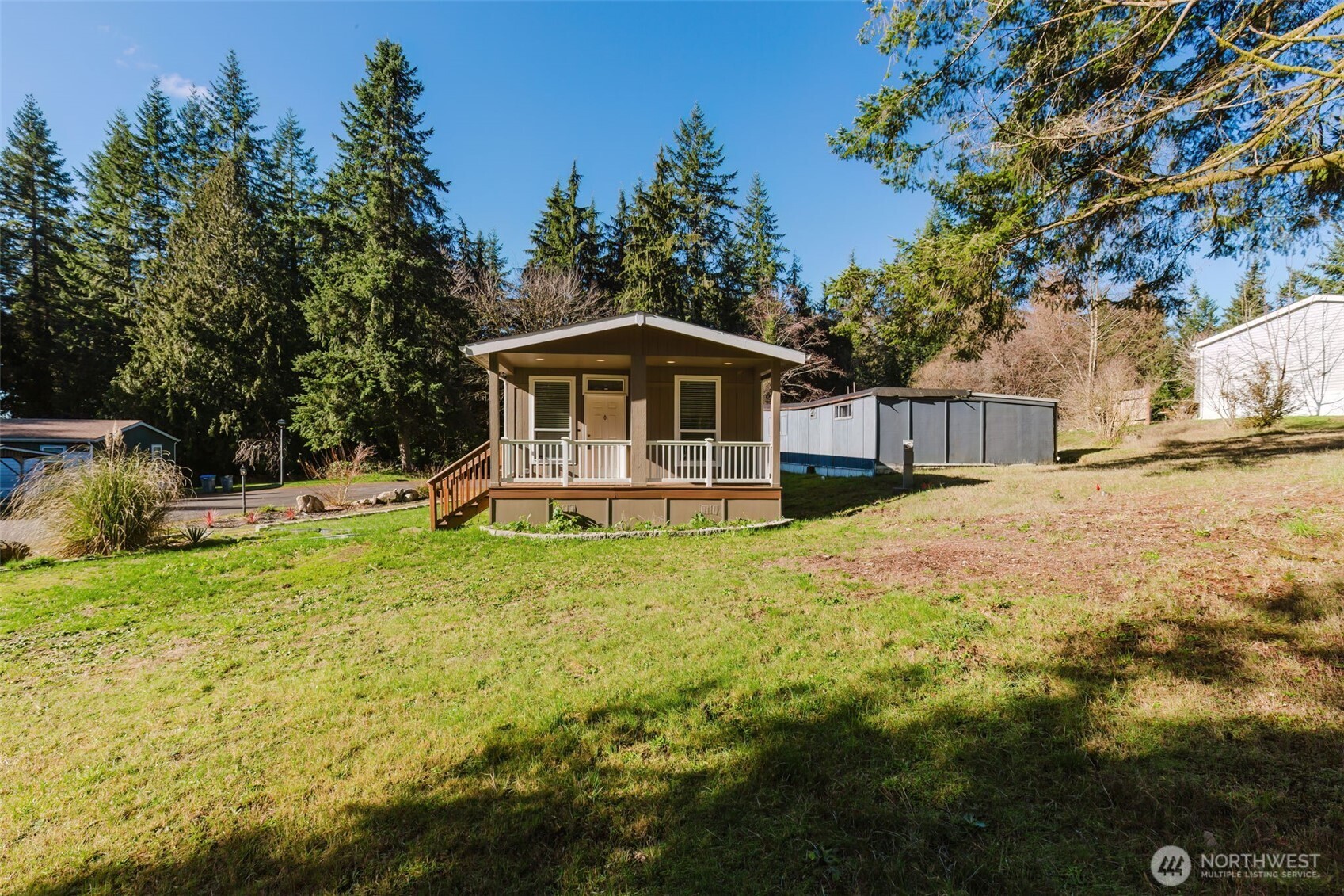 3371 Southeast Bielmeier Road, Unit 95 Port Orchard, WA 98367 - Photo 6 of 40 a front view of a house with yard and green space
