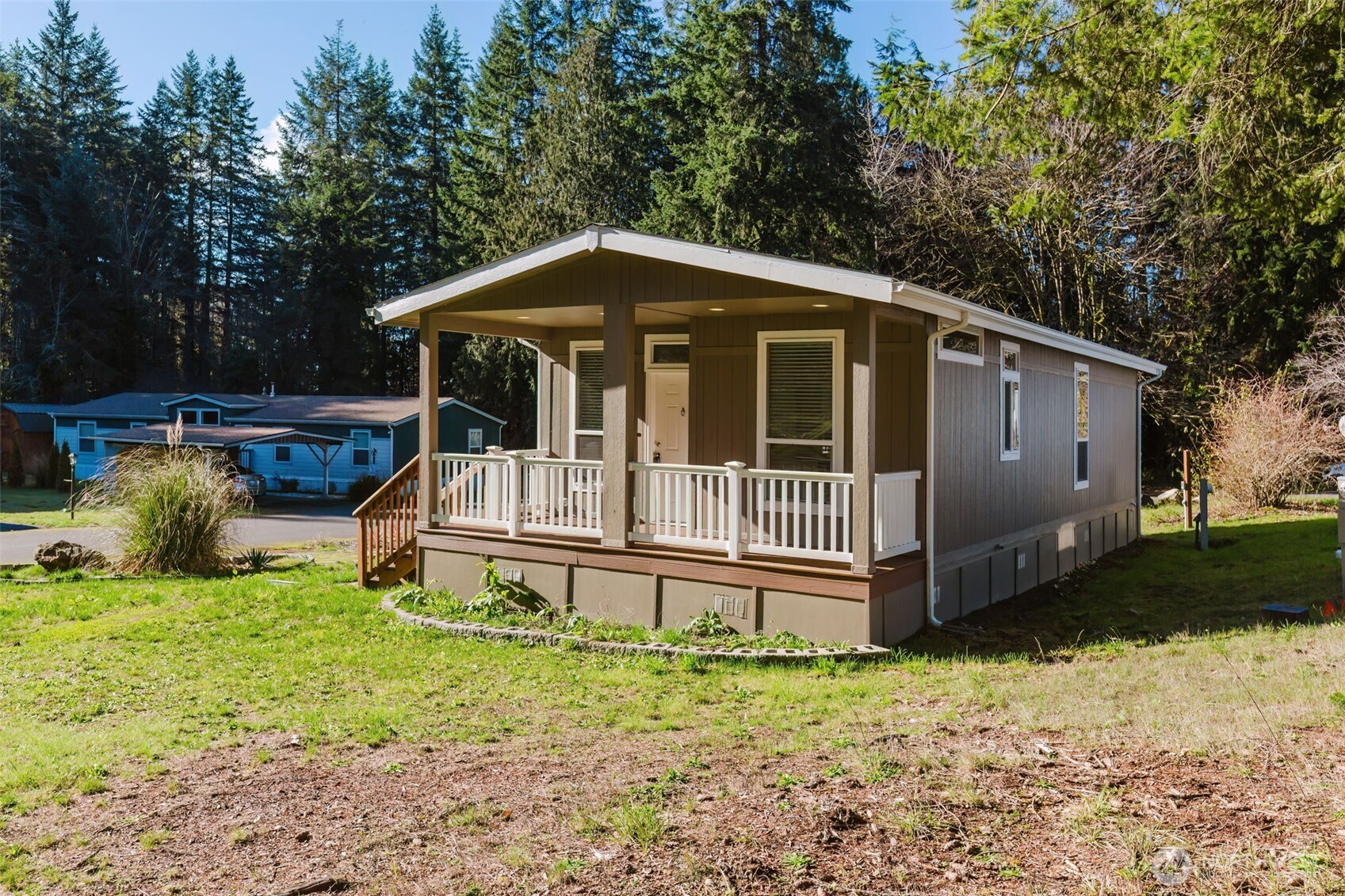 3371 Southeast Bielmeier Road, Unit 95 Port Orchard, WA 98367 - Photo 7 of 40 a view of a house with a yard and wooden fence