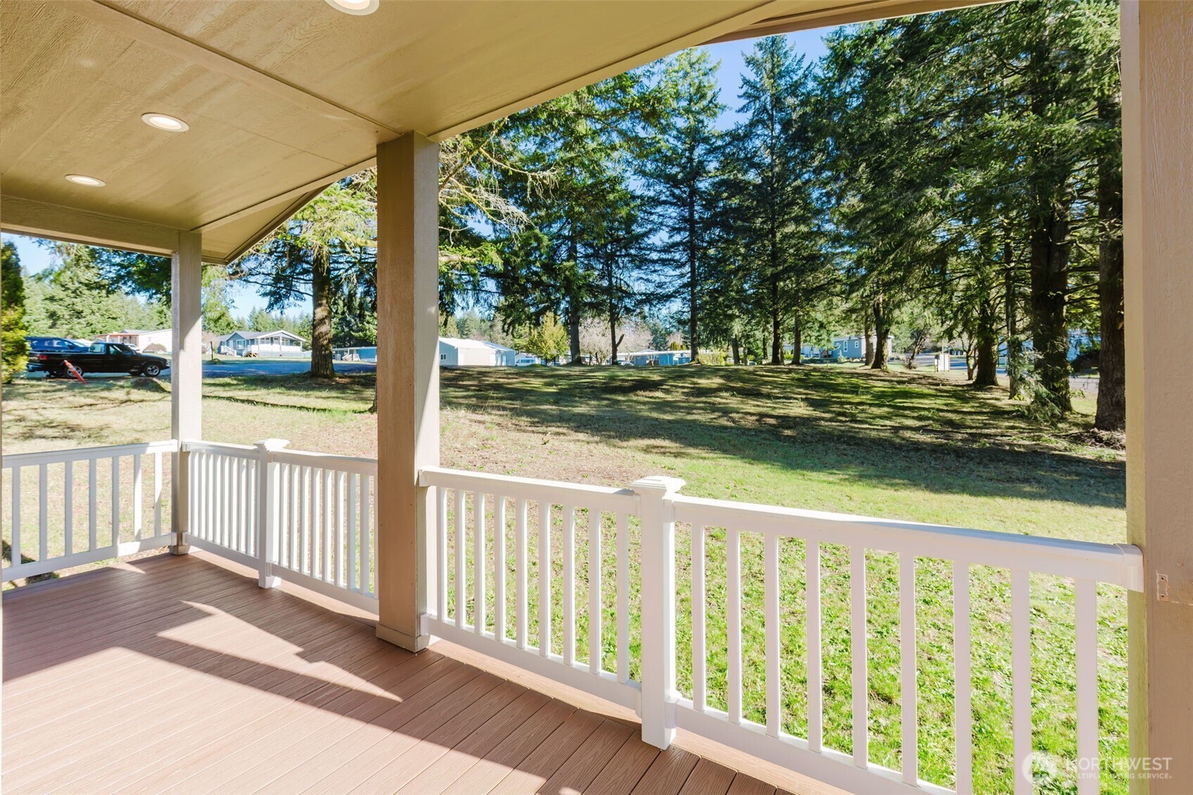 3371 Southeast Bielmeier Road, Unit 95 Port Orchard, WA 98367 - Photo 9 of 40 a porch with a trees in front of it