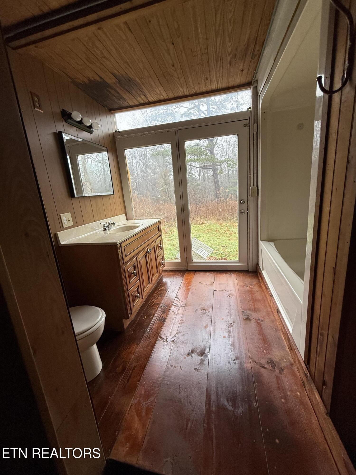 321 Wheeler Lane Jamestown, TN 38556 - Photo 20 of 23 a bathroom with a toilet a sink and a large window