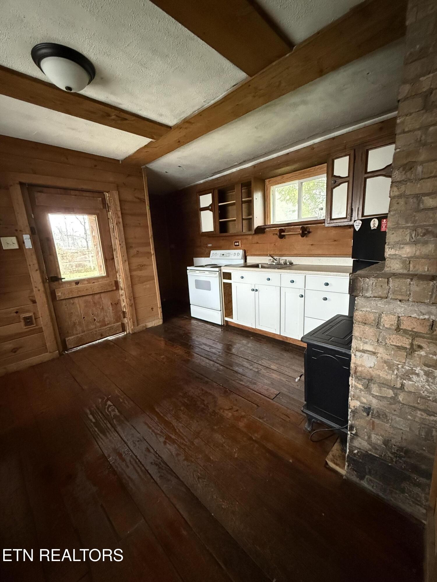 321 Wheeler Lane Jamestown, TN 38556 - Photo 8 of 23 a kitchen with stainless steel appliances wooden floor and a refrigerator