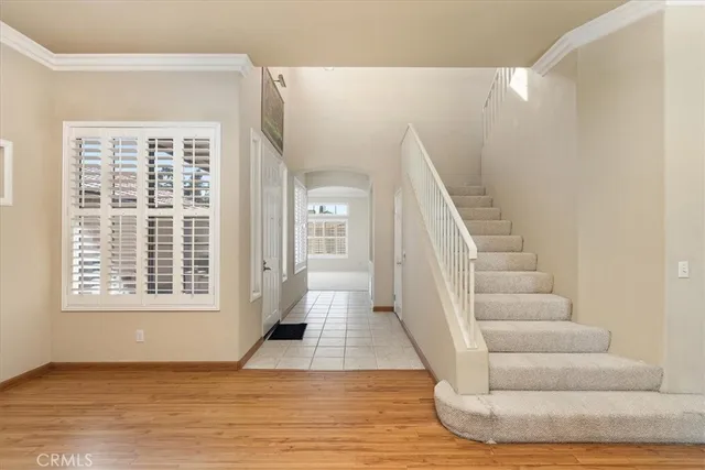 a view of entryway and hall with wooden floor