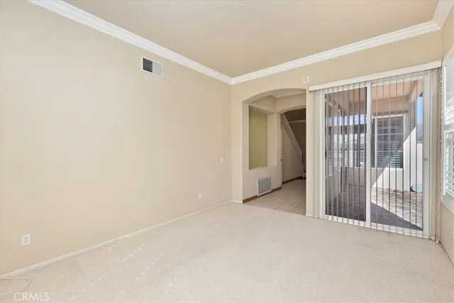a view of an empty room with glass door