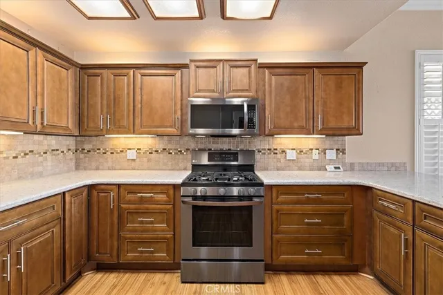 a kitchen with granite countertop a stove sink and cabinets