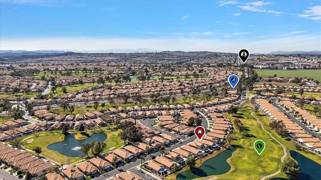 an aerial view of residential houses with outdoor space