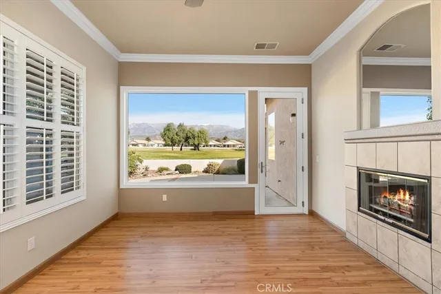 a view of open kitchen with furniture and a fireplace