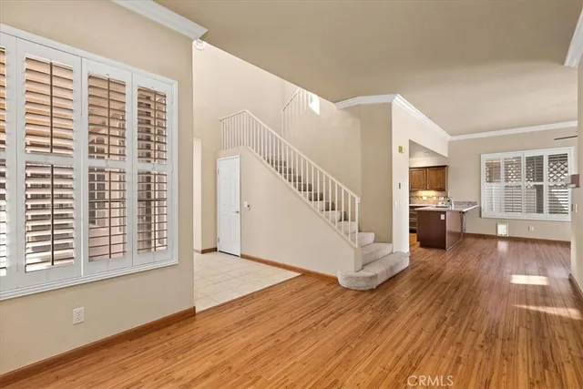 a view of a living room with wooden floor and a large window
