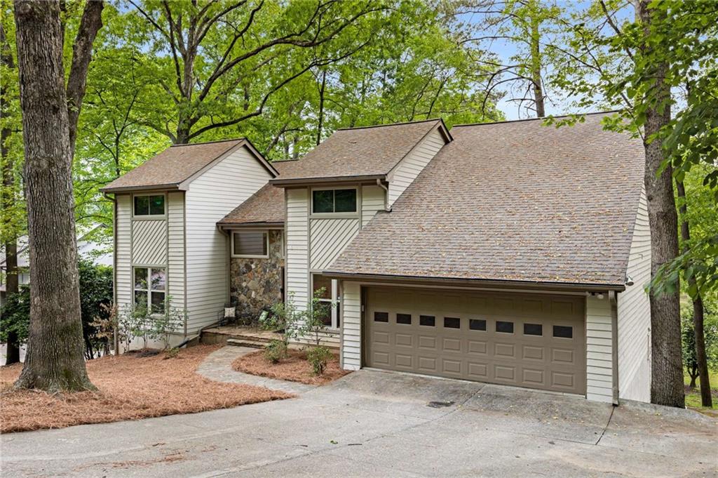 9295 Martin Road Roswell, GA 30076 - Photo 1 of 1 a front view of a house with a yard and garage