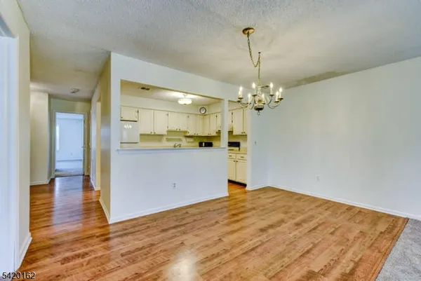 a view of a kitchen with wooden floor and a kitchen