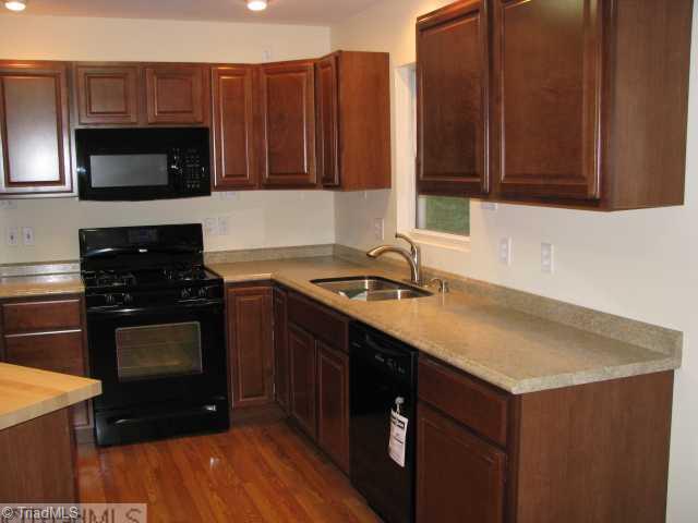 3241 Sheppard Mill Road Sandy Ridge, NC 27046 - Photo 4 of 16 Kitchen. All new flooring, counter tops and appliances with butcher block island.
