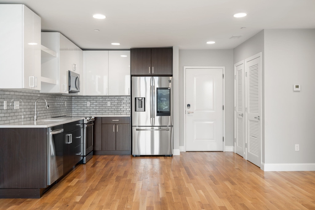 10 Taber Street, Unit 503 Boston, MA 02119 - Photo 1 of 21 a kitchen with stainless steel appliances granite countertop a refrigerator and a sink