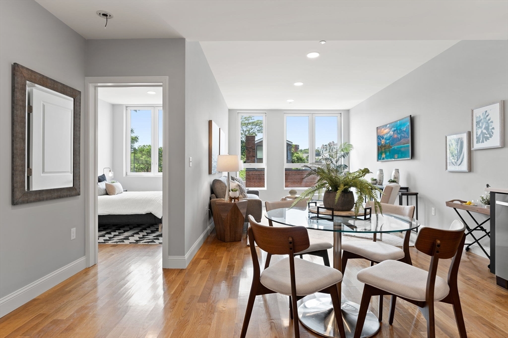 10 Taber Street, Unit 503 Boston, MA 02119 - Photo 15 of 21 a view of a dining room with furniture window and wooden floor