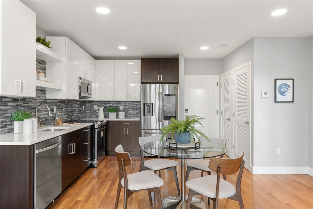 10 Taber Street, Unit 503 Boston, MA 02119 - Photo 2 of 21 a kitchen with a table and chairs in it