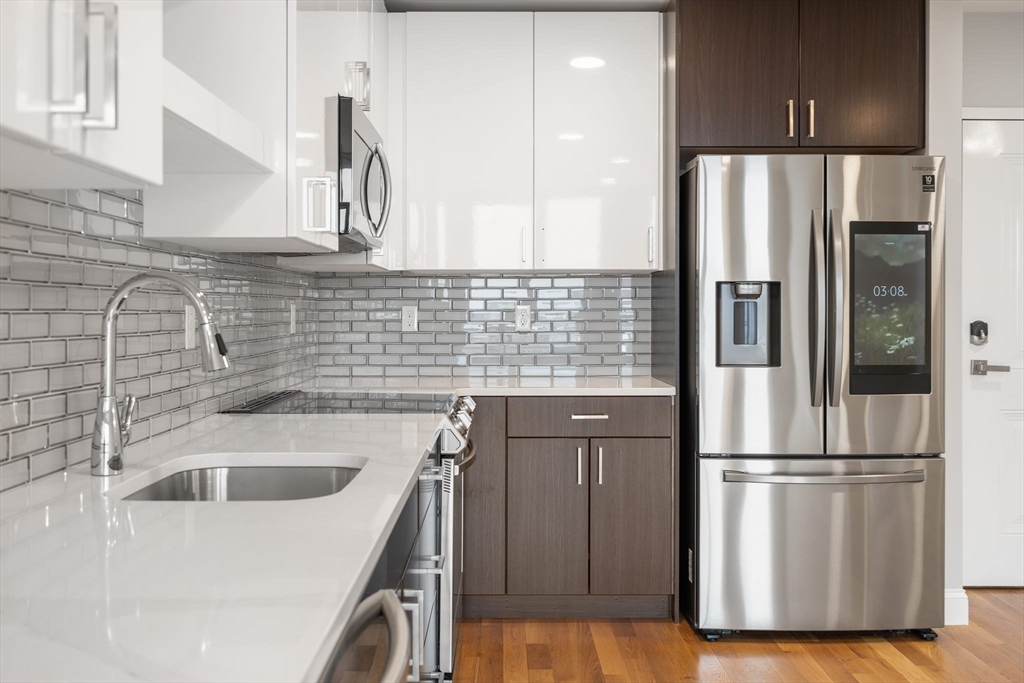 10 Taber Street, Unit 503 Boston, MA 02119 - Photo 4 of 21 a kitchen with stainless steel appliances granite countertop a refrigerator and a sink