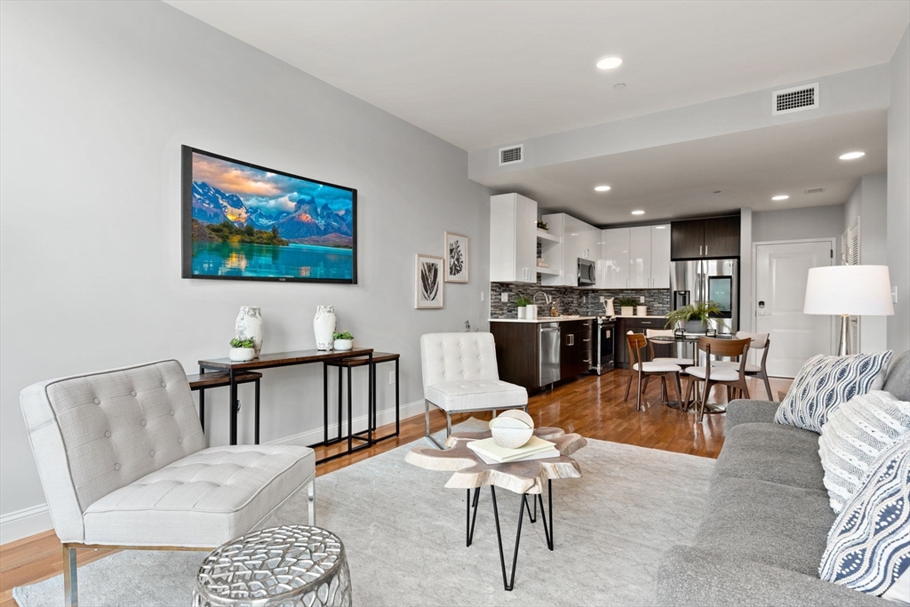 10 Taber Street, Unit 503 Boston, MA 02119 - Photo 7 of 21 a living room with furniture kitchen view and a dining table