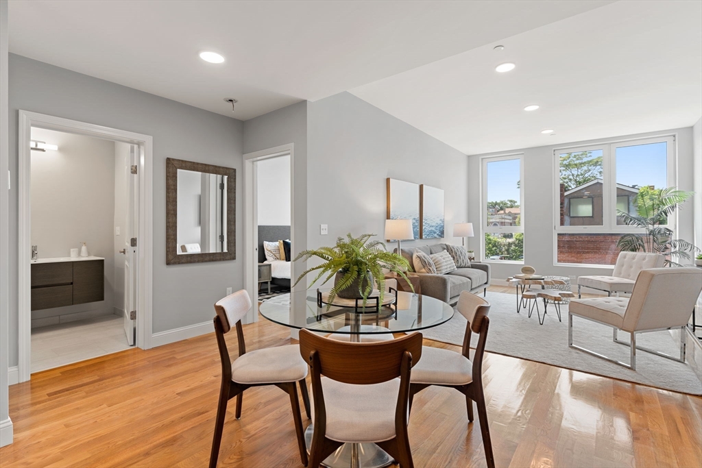 10 Taber Street, Unit 503 Boston, MA 02119 - Photo 9 of 21 a dining room with furniture a window and wooden floor