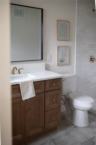 a bathroom with a sink toilet and mirror