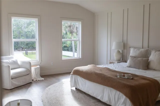 a bedroom with a bed and a couch with window
