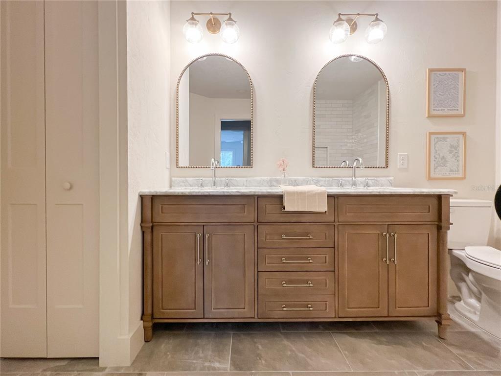 320 Rodeo Road Ormond Beach, FL 32174 - Photo 33 of 53 a bathroom with a double vanity sink and a mirror