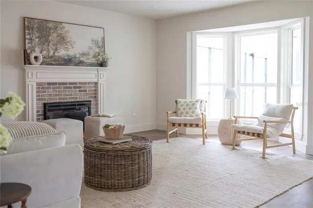 a living room with furniture a fireplace and a window