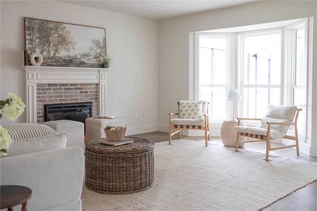 320 Rodeo Road Ormond Beach, FL 32174 - Photo 6 of 53 a living room with furniture a fireplace and a window