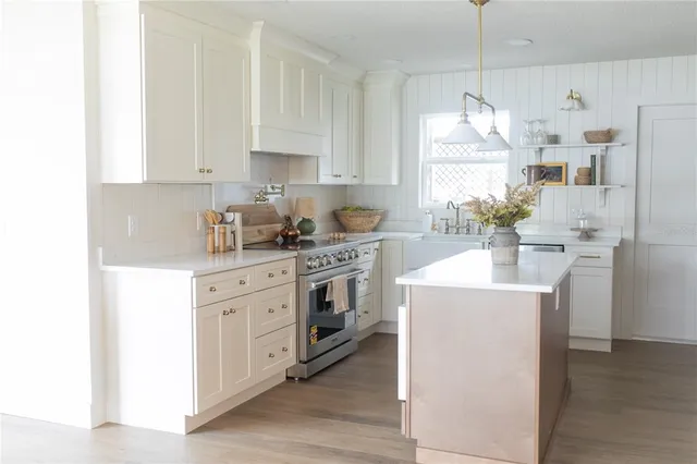a kitchen with a stove a sink and a refrigerator