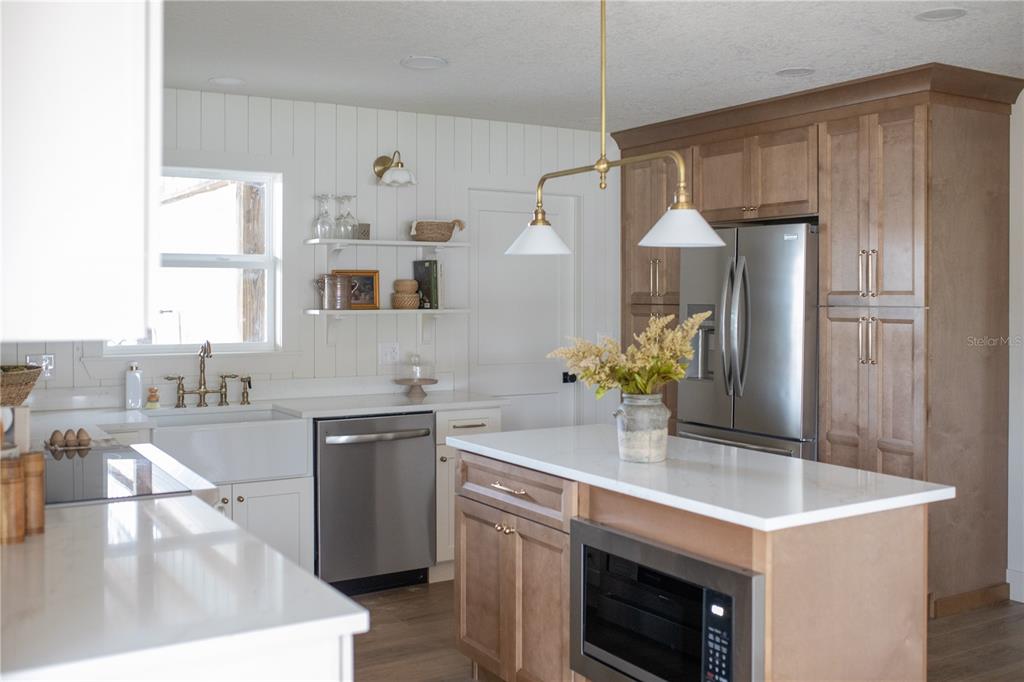 320 Rodeo Road Ormond Beach, FL 32174 - Photo 8 of 53 a kitchen with stainless steel appliances granite countertop a sink and a refrigerator
