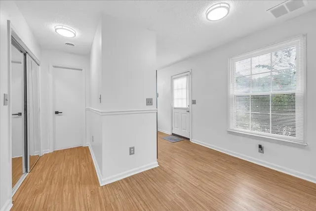 wooden floor in an empty room with a window