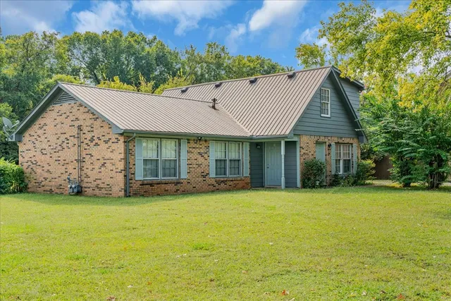 a front view of a house with a garden