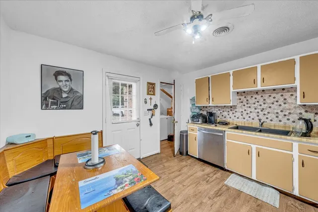 a kitchen with stainless steel appliances granite countertop a sink dishwasher stove and refrigerator