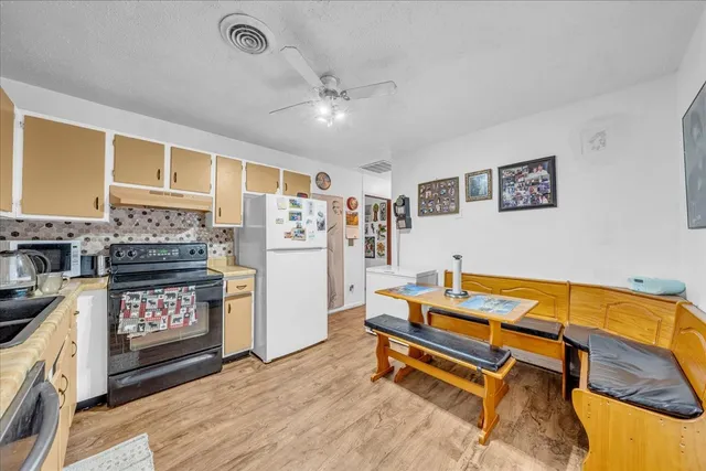 a reading room with furniture and ceiling fan