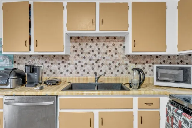a kitchen with a stove and a sink