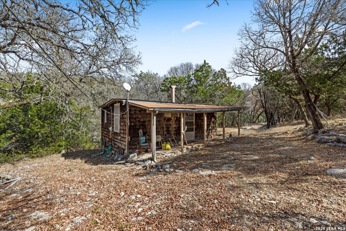 2633 Jackson Creek Road Medina, TX 78055 - Photo 3 of 27 a view of house with backyard space and balcony