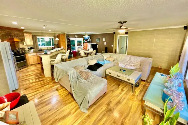 a living room with lots of furniture dining table and kitchen view