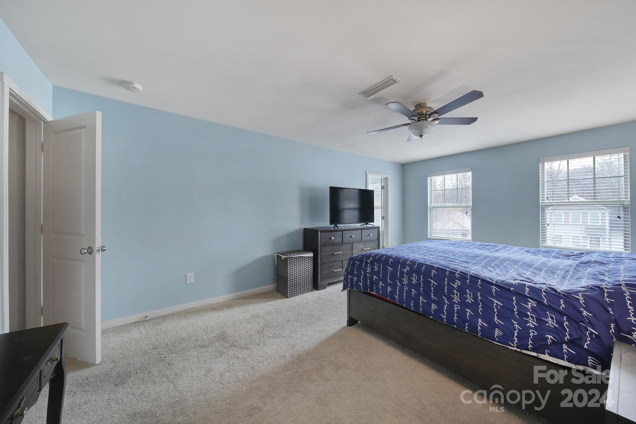1539 Logan Patrick Court Gastonia, NC 28052 - Photo 12 of 26 a bedroom with a large bed a flat tv screen and dresser