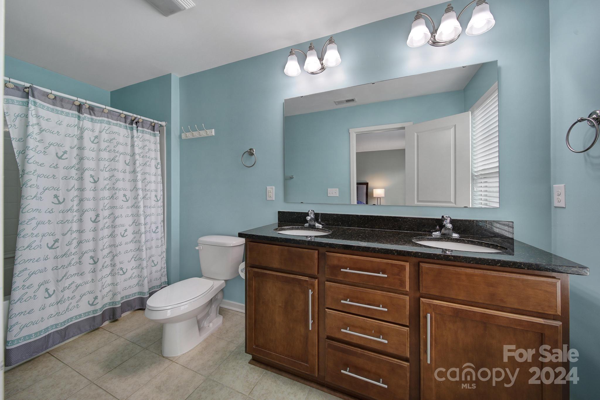 1539 Logan Patrick Court Gastonia, NC 28052 - Photo 13 of 26 a bathroom with a toilet a sink and mirror