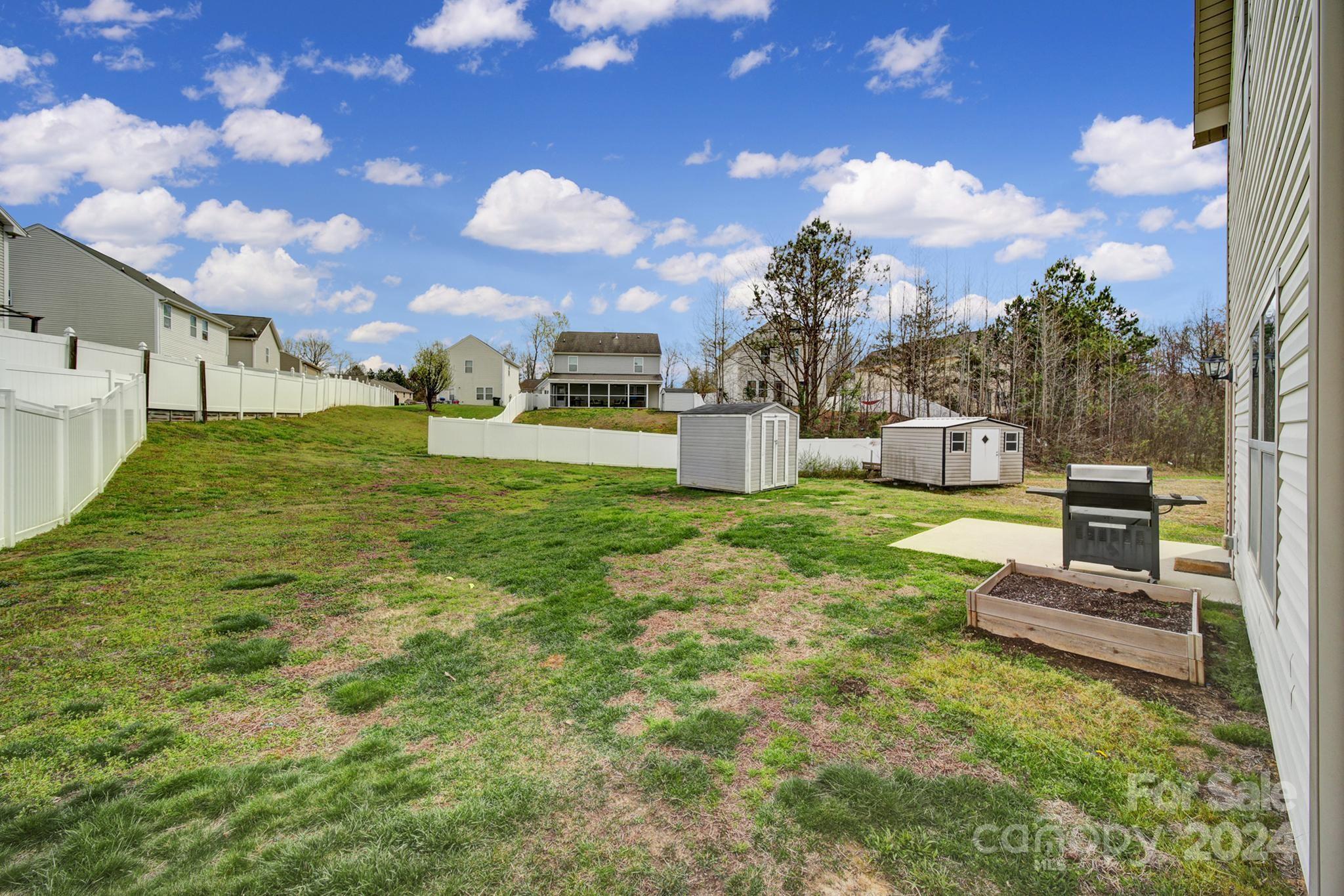 1539 Logan Patrick Court Gastonia, NC 28052 - Photo 20 of 26 a view of a patio with table and chairs with a yard