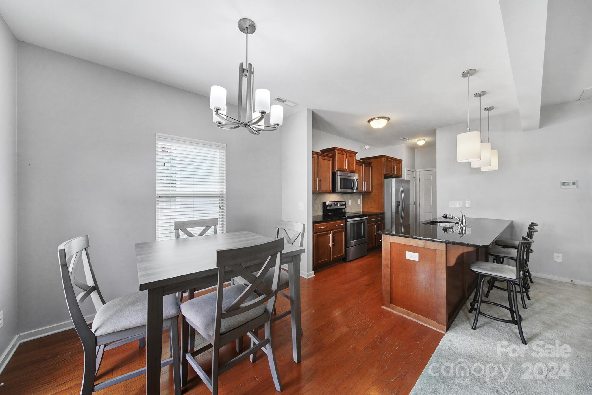 1539 Logan Patrick Court Gastonia, NC 28052 - Photo 5 of 26 a view of a dining room with furniture window and wooden floor
