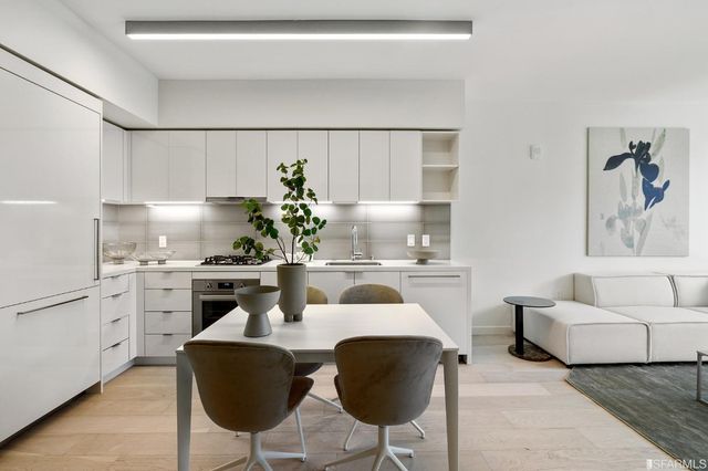 a kitchen with stainless steel appliances granite countertop a sink and a refrigerator