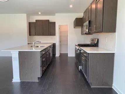 a kitchen with stainless steel appliances a sink stove and cabinets
