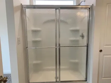 a bathroom with a glass shower door
