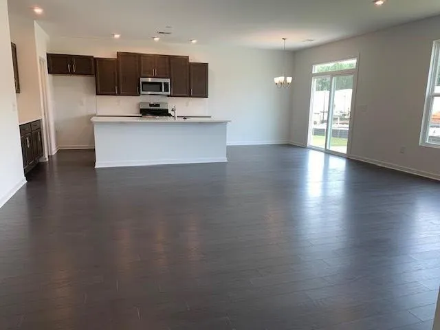 a view of kitchen with sink and refrigerator