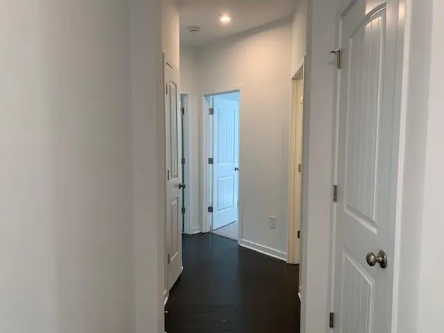 a view of a hallway with wooden floor