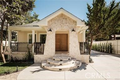 a view of a house with large windows and couches