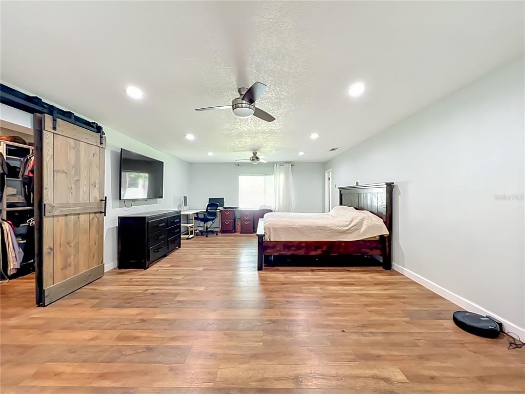 153 Variety Tree Circle Altamonte Springs, FL 32714 - Photo 22 of 44 a spacious bedroom with a bed and a view of kitchen