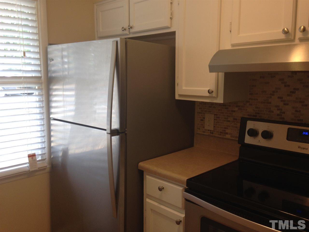 7752 Sandra Lane Raleigh, NC 27615 - Photo 6 of 6 a kitchen with a refrigerator and a stove