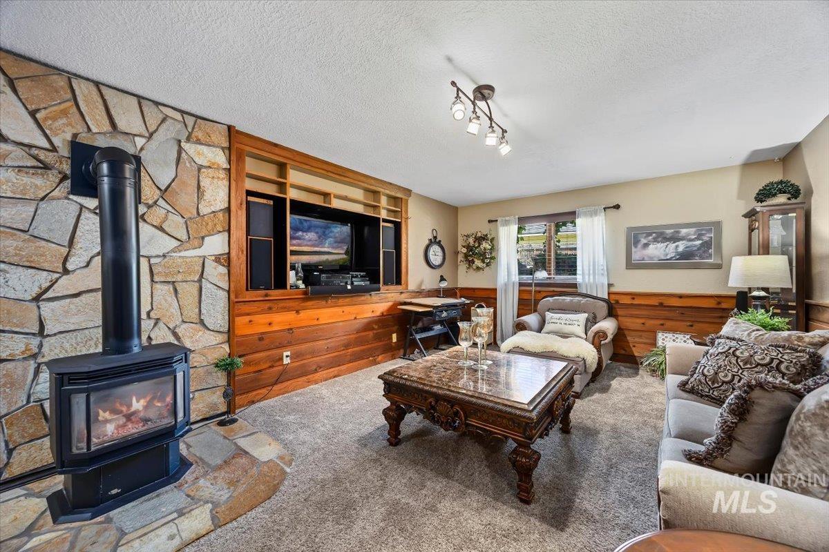 956 Bitterroot Place Twin Falls, ID 83301 - Photo 15 of 48 Living area featuring a stone accent wall with a freestanding fireplace
